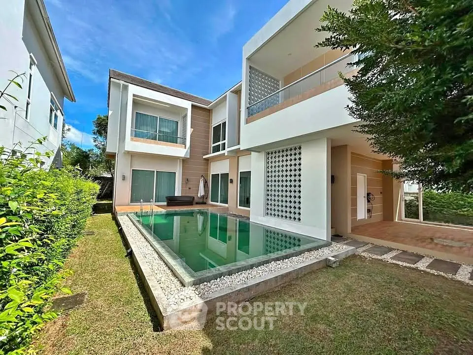 Luxurious modern home with private pool and lush garden, perfect for serene living.