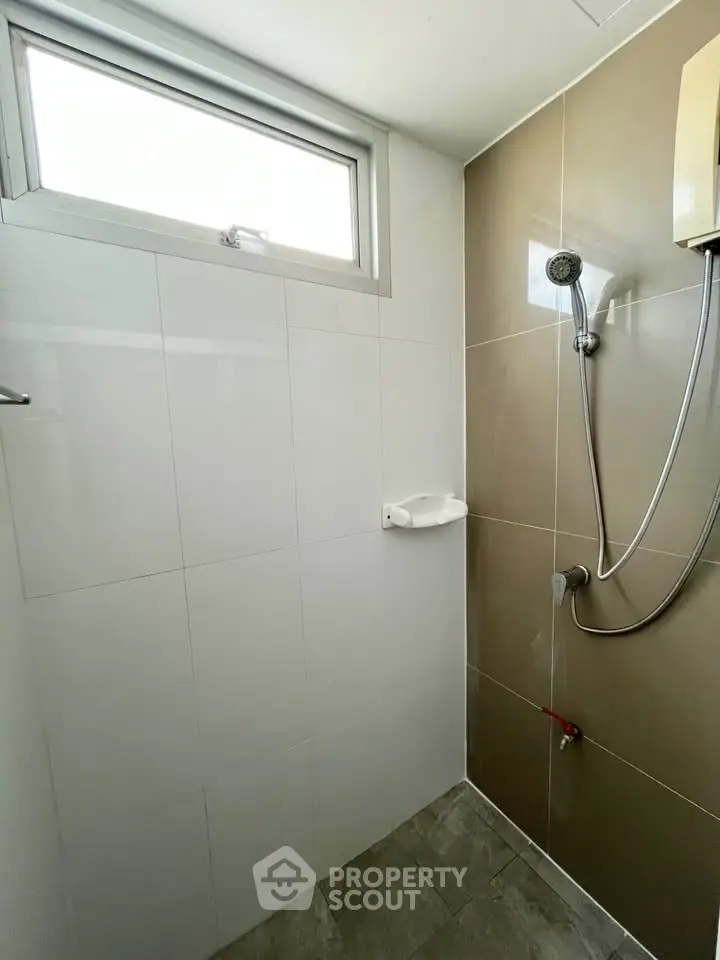 Modern bathroom with sleek shower design and neutral tiles