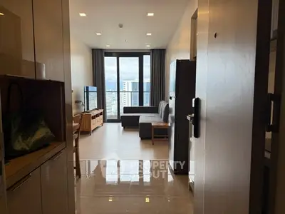 Modern living room with city view, featuring sleek furniture and large windows for natural light.