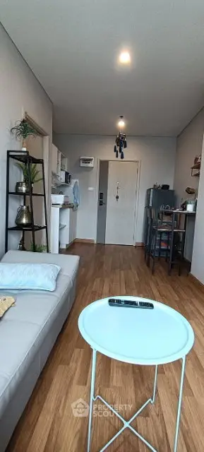 Modern living room with sleek furniture and open kitchen layout, perfect for cozy urban living.
