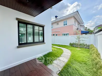 Charming garden view with modern house exterior and lush green landscaping.