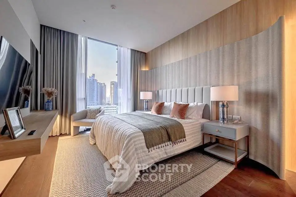 Luxurious bedroom with city view, modern decor, and elegant furnishings in a high-rise apartment.