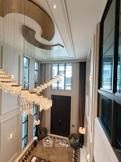 Luxurious living room with high ceilings and elegant chandelier