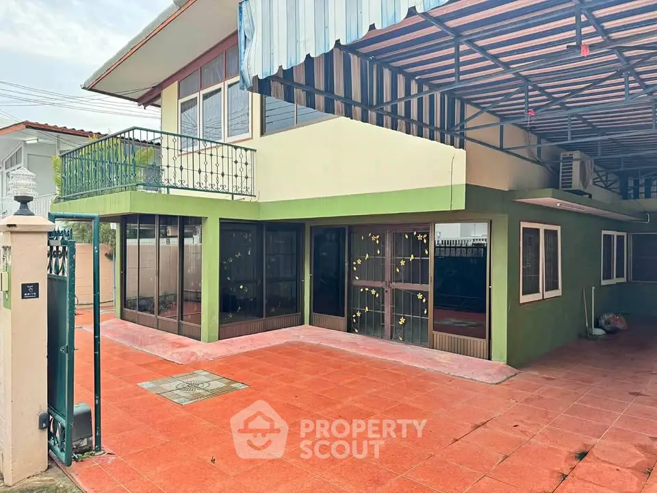 Charming two-story house with spacious patio and balcony, perfect for outdoor living.