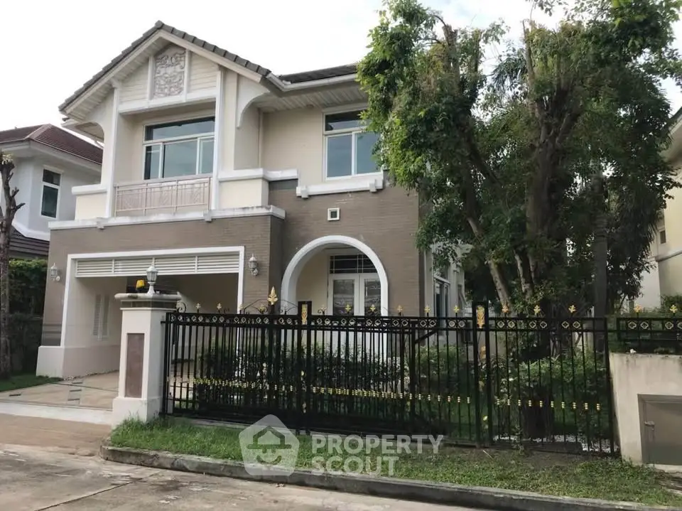 Charming two-story house with elegant facade and lush greenery in a serene neighborhood.