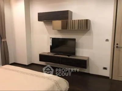 Modern bedroom with sleek TV unit and stylish wall cabinets