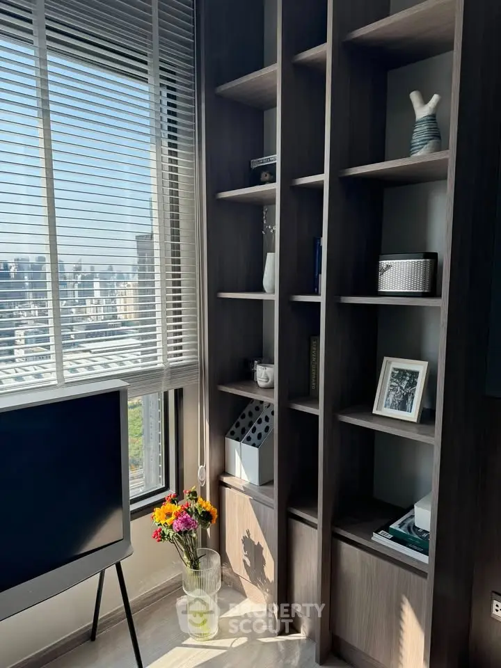 Modern living room with city view, stylish shelving, and natural light