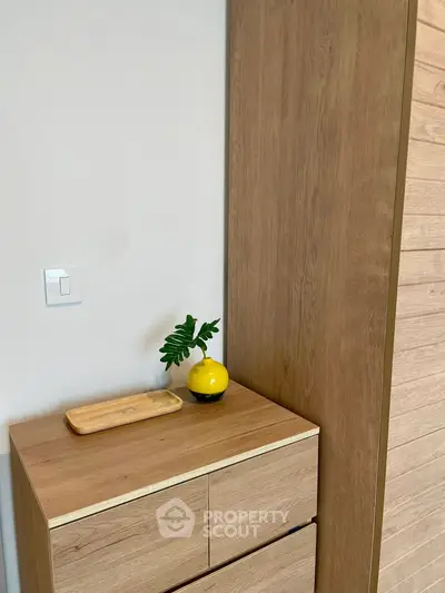 Modern wooden storage unit with decorative plant in stylish interior