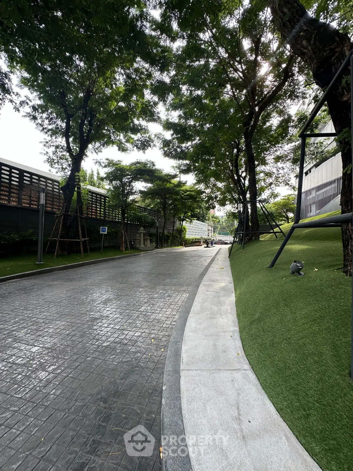 Serene tree-lined pathway in a modern residential complex