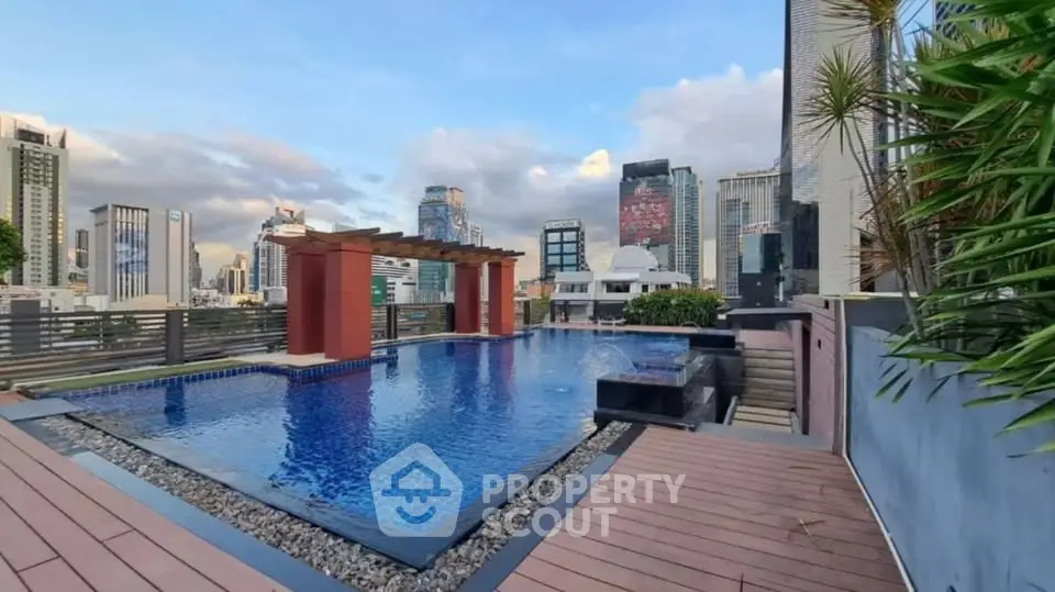 Luxurious rooftop pool with stunning city skyline views, perfect for relaxation and entertainment.