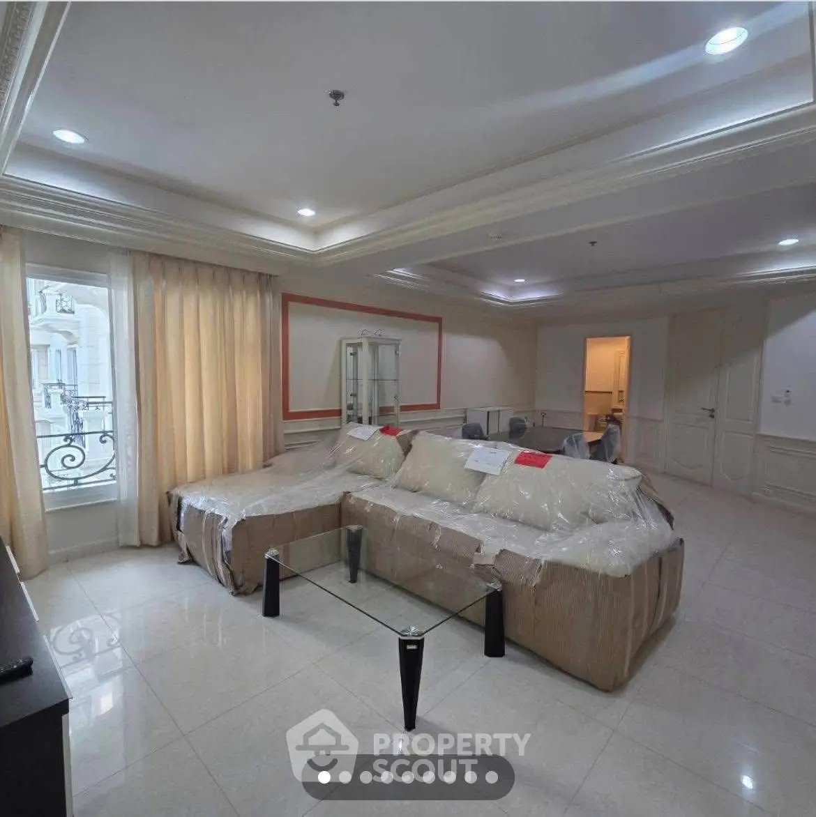 Spacious living room with elegant furniture and large windows for natural light.