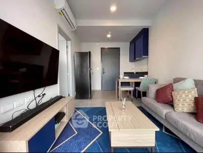 Modern living room with stylish decor and open layout, featuring a cozy seating area and sleek entertainment setup.