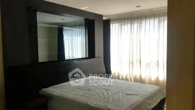 Cozy bedroom with large window and modern decor