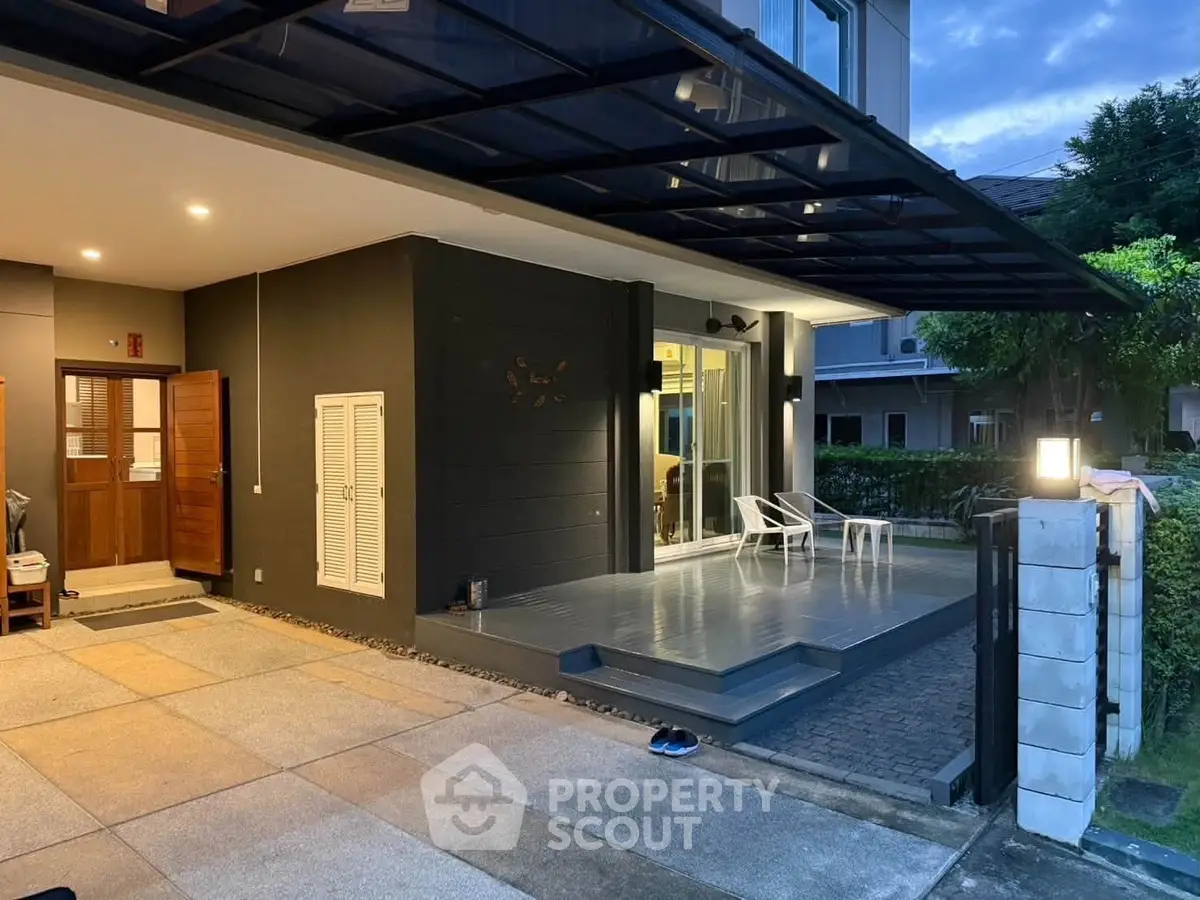 Modern home exterior with sleek design and inviting entrance at dusk, showcasing contemporary architecture.