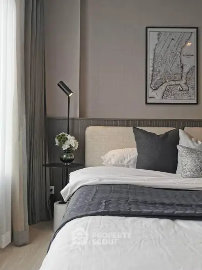 Elegant bedroom with modern decor and cozy bedding in a stylish apartment.