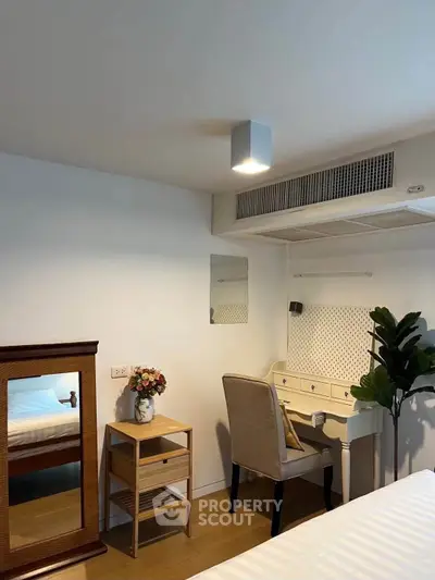 Charming bedroom with elegant vanity and cozy decor, perfect for relaxation and style.