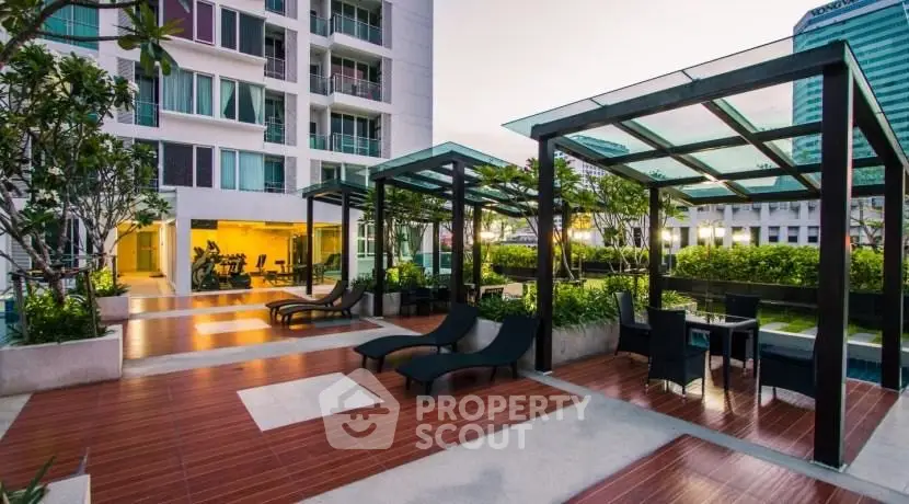 Luxurious modern apartment complex with outdoor lounge and gym facilities.