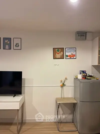 Modern living room with stylish decor and compact kitchen appliances, perfect for urban living.