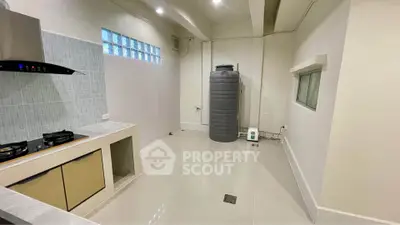 Spacious kitchen with modern gas stove and ample storage space