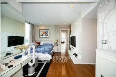 Modern bedroom with stylish decor and hardwood floors in a luxury apartment.