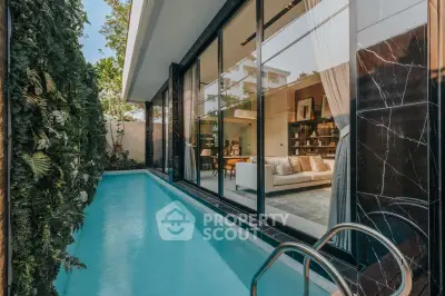 Luxurious modern home with private pool and lush greenery