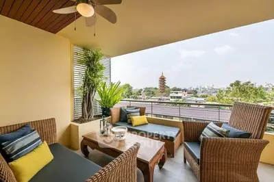 Charming balcony with cozy seating and city view, perfect for relaxation and entertaining.