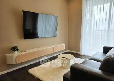 Modern living room with sleek TV, cozy sofa, and stylish decor