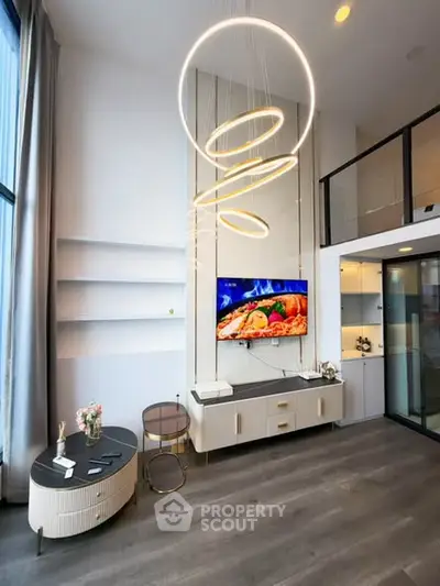 Modern living room with stylish lighting and open kitchen layout