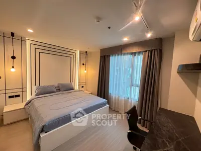 Modern bedroom with stylish decor, large bed, and natural light from window, perfect for urban living.