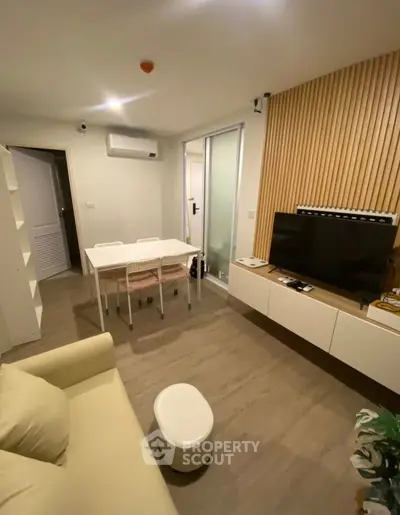 Modern living room with sleek furniture and wooden accents, perfect for cozy gatherings.