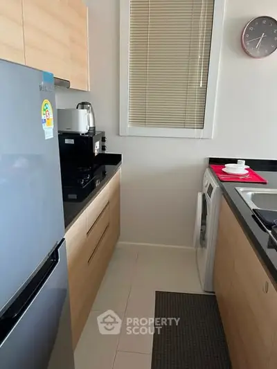 Modern kitchen with sleek appliances and ample storage in a compact layout.