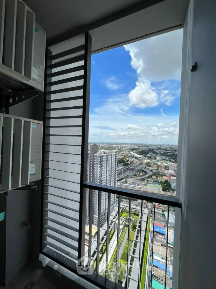 Stunning high-rise balcony view overlooking cityscape with clear blue skies.