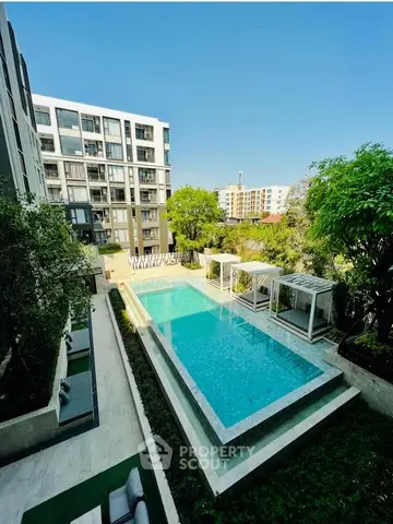 Luxurious apartment complex with stunning outdoor pool and modern architecture.