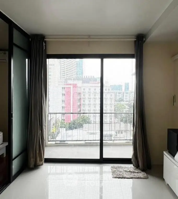 Spacious apartment with large windows offering stunning city views and abundant natural light.