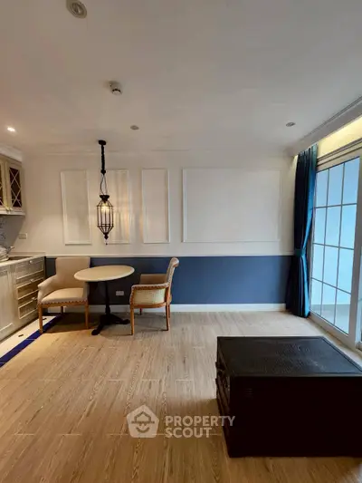 Charming living room with elegant dining area and large windows for natural light.