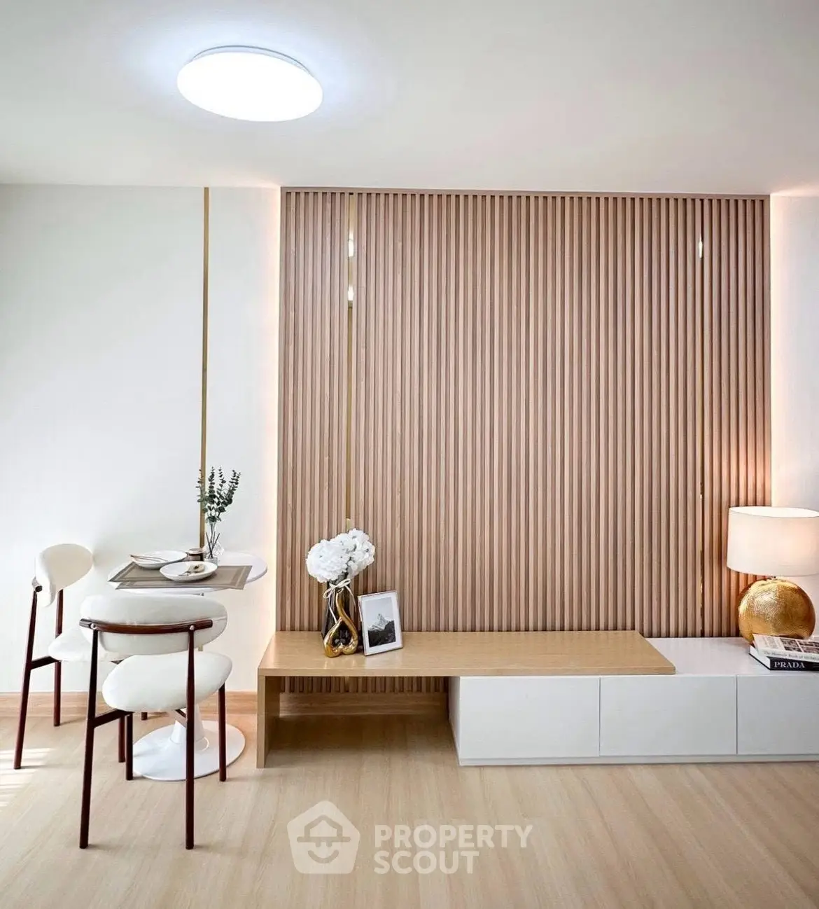 Modern dining area with sleek wooden paneling and elegant decor in a contemporary apartment.