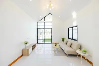 Spacious modern living room with high ceiling and large windows