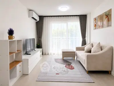 Modern living room with stylish decor, natural light, and cozy seating in a contemporary apartment.