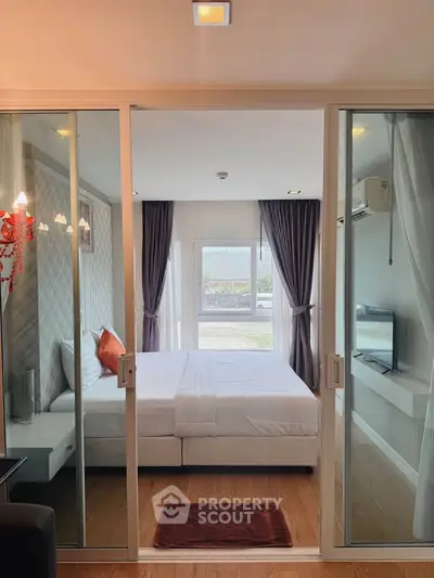 Modern bedroom with glass sliding doors and natural light