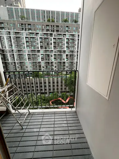 Modern apartment balcony with city view and sleek railing design.