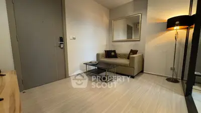 Modern living room with sleek sofa and stylish floor lamp in a cozy apartment.