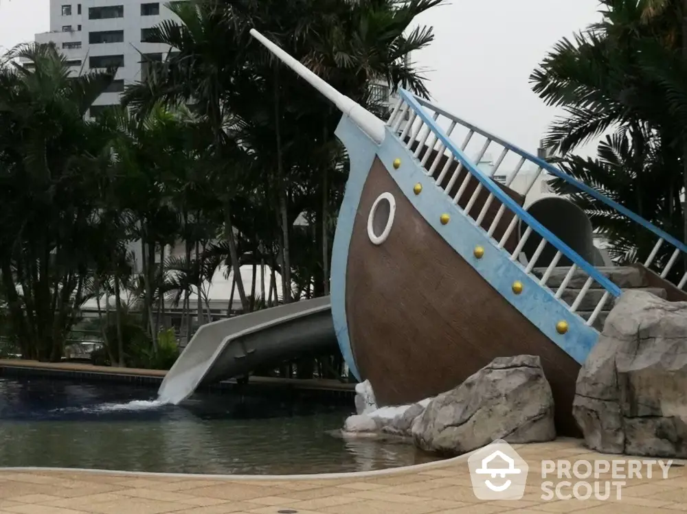 Luxurious pool area with unique ship-themed slide in tropical setting