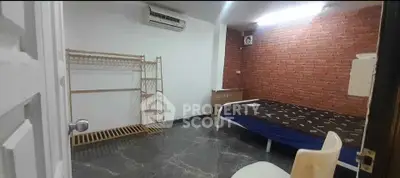 Cozy bedroom with brick accent wall and modern furnishings