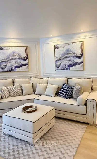 Elegant living room with plush sectional sofa and modern art decor