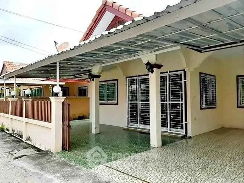 Charming single-story home with covered carport and gated entrance