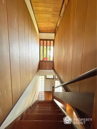 Charming wooden staircase with natural light and classic design