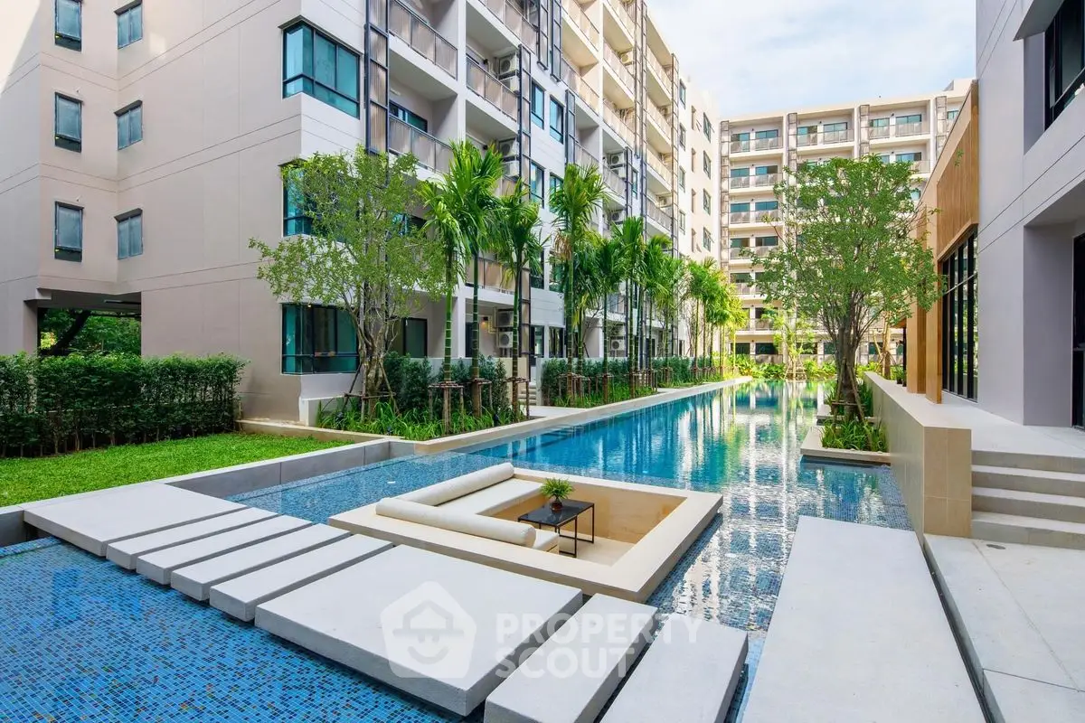 Luxurious apartment complex with stunning pool and lush greenery