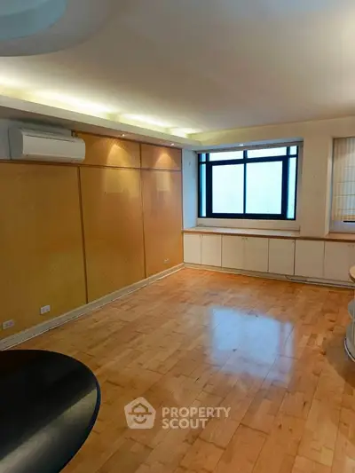 Spacious living room with wooden flooring and large window