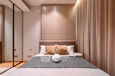 Luxurious modern bedroom with elegant decor and mirrored wardrobe