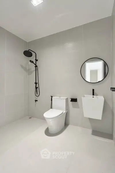 Modern minimalist bathroom with sleek fixtures and neutral tones.